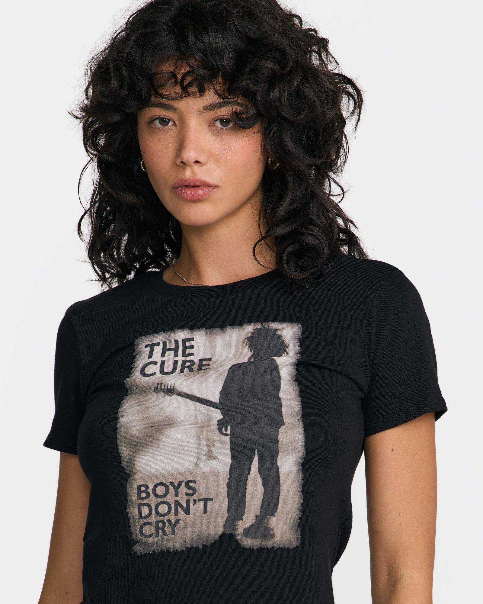 Woman wearing black t-shirt with The Cure 'Boys Don't Cry' album artwork, front view close-up