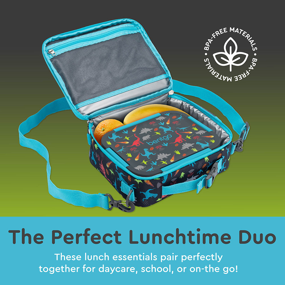 Open insulated lunch bag with dinosaur print containing an orange and sandwich, showing mesh pocket and internal organization