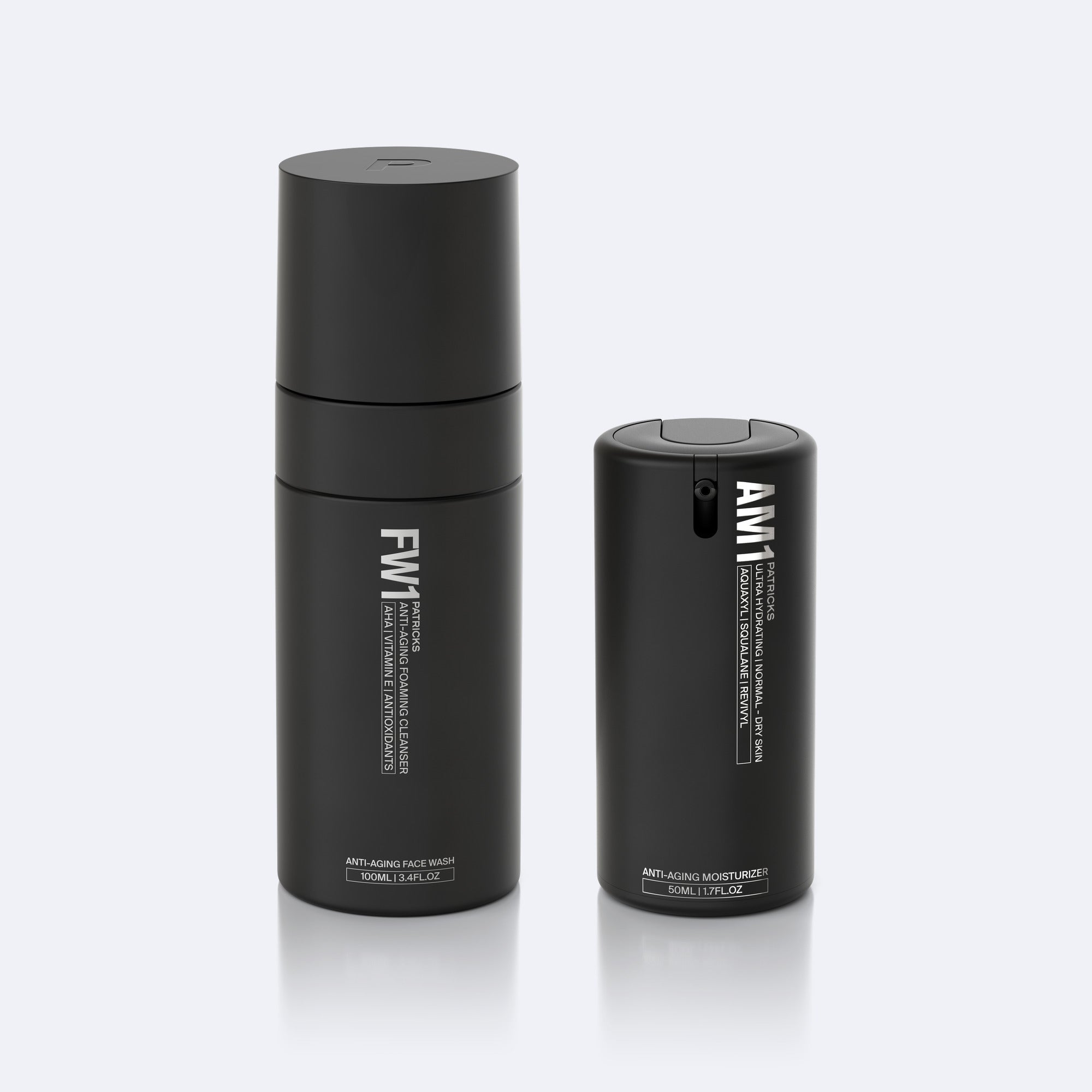 Two tall black cylindrical bottles side by side on white background