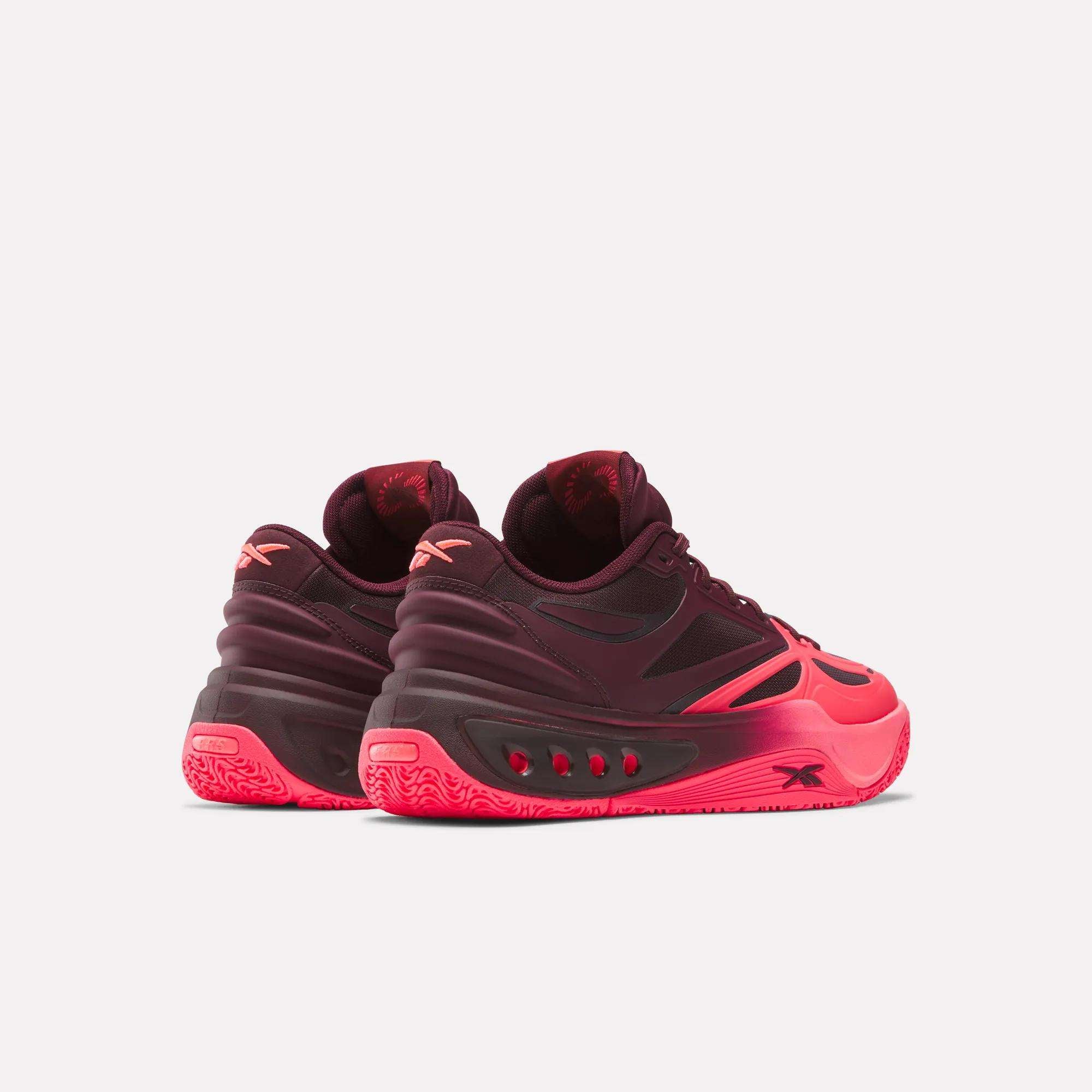 Rear view of burgundy and neon pink sneakers displaying textured sole and heel design