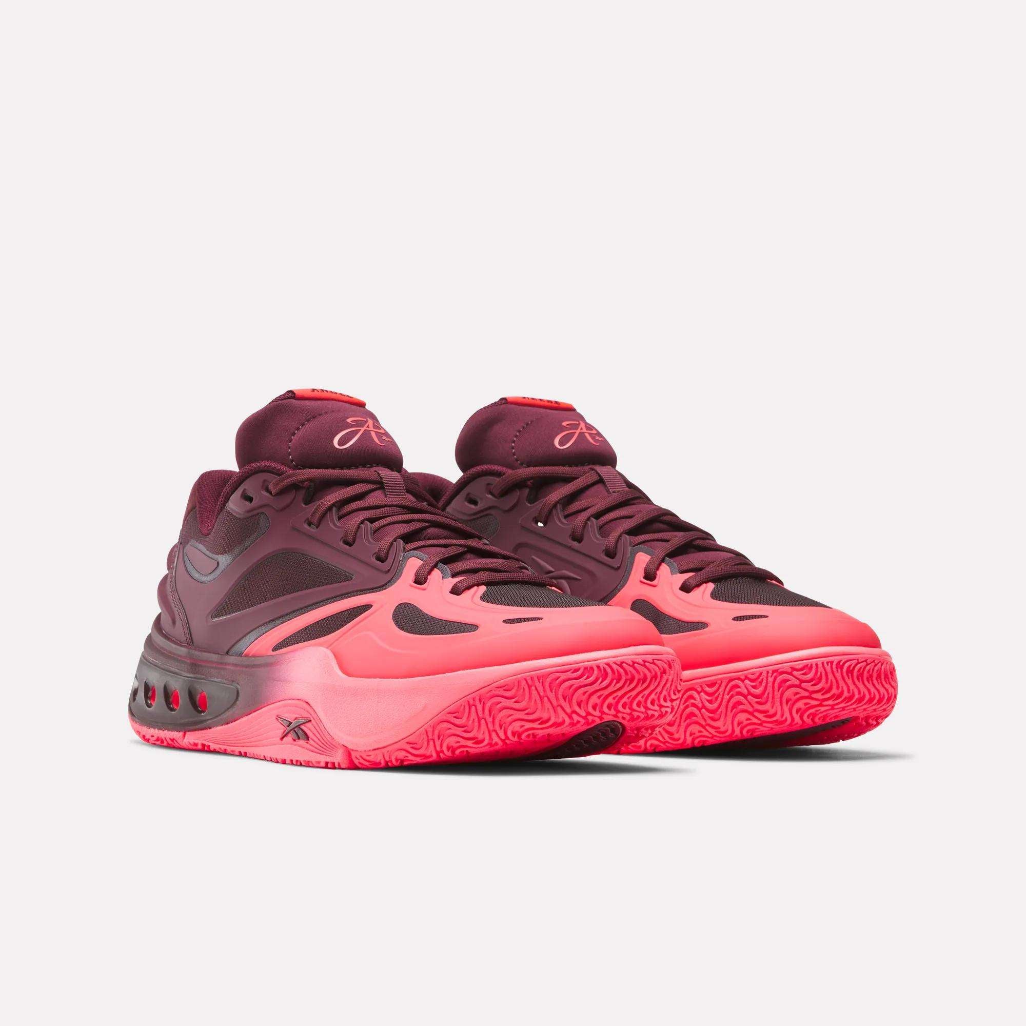 Side profile of burgundy and neon pink sneakers showing layered midsole construction