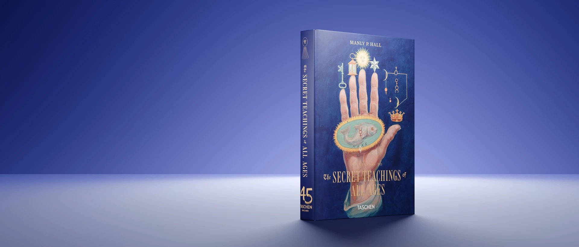 Blue book cover 'The Secret Teachings of All Ages' by Manly P. Ball, featuring ornate hand illustration with mystical symbols and stars