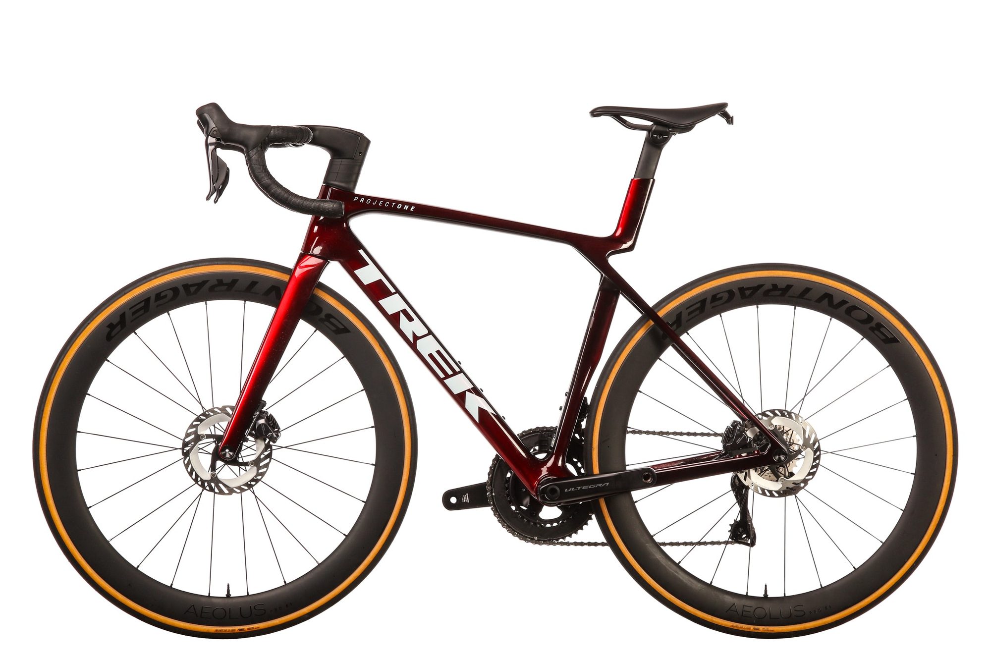 Red and maroon gravel bike with gold-rimmed wheels shown from the side against white background