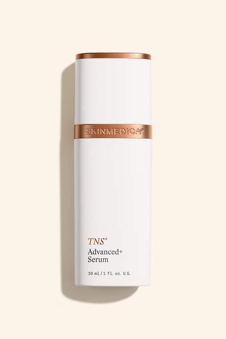Single white bottle with copper band labeled 'TNS Advanced+ Serum' against neutral background