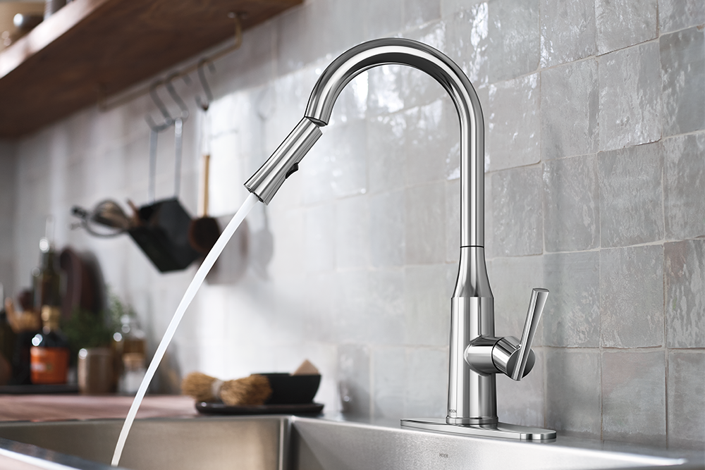 Chrome pull-down kitchen faucet with spray nozzle extended over sink