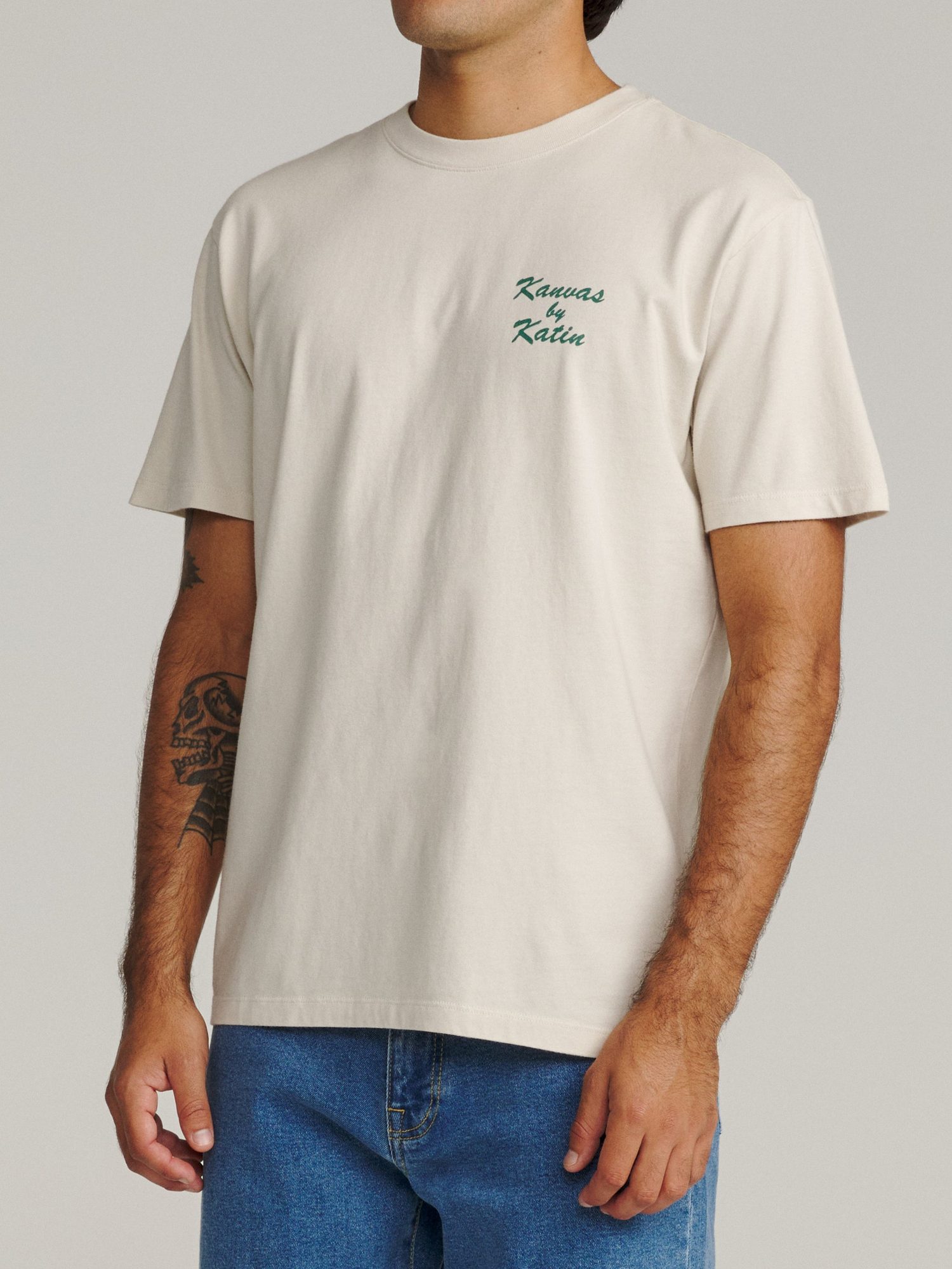 Front view of cream t-shirt with small green 'Kanvas by Katin' chest embroidery