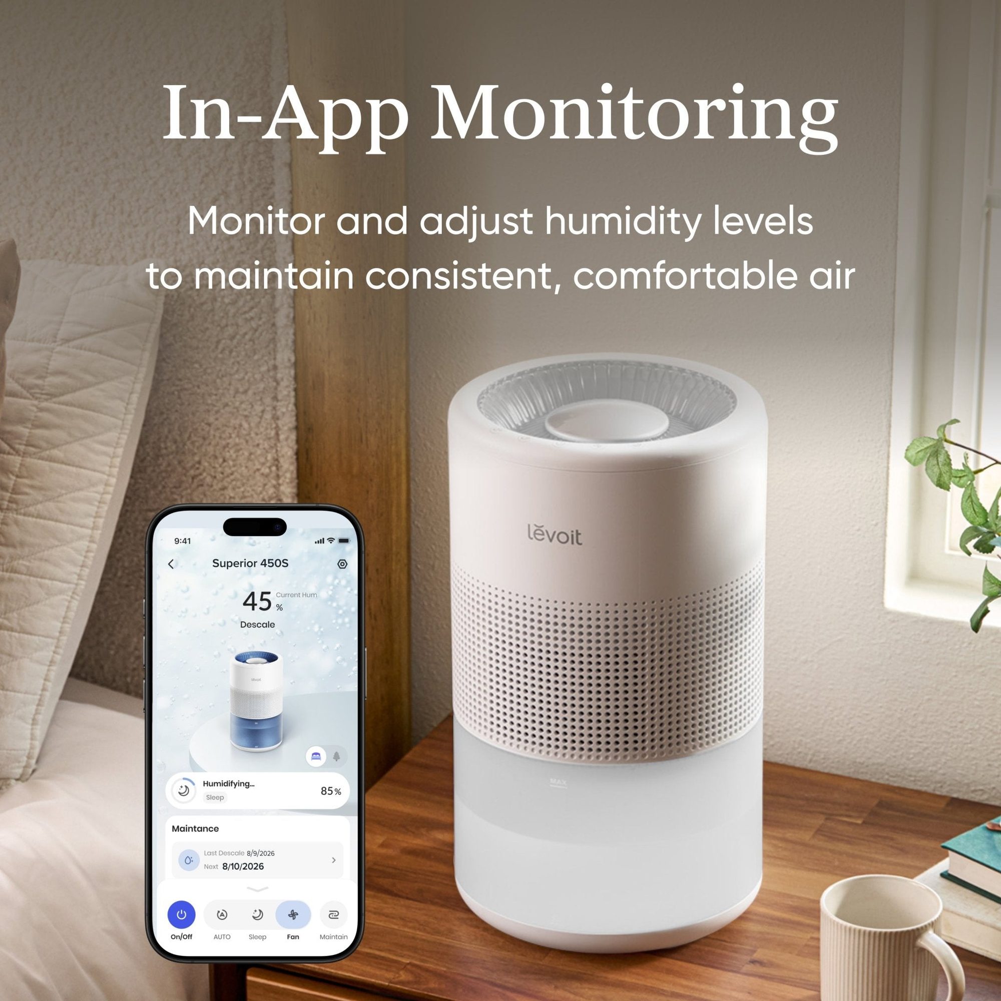 Smartphone app displaying humidity monitoring at 85% next to white cylindrical humidifier on wooden table