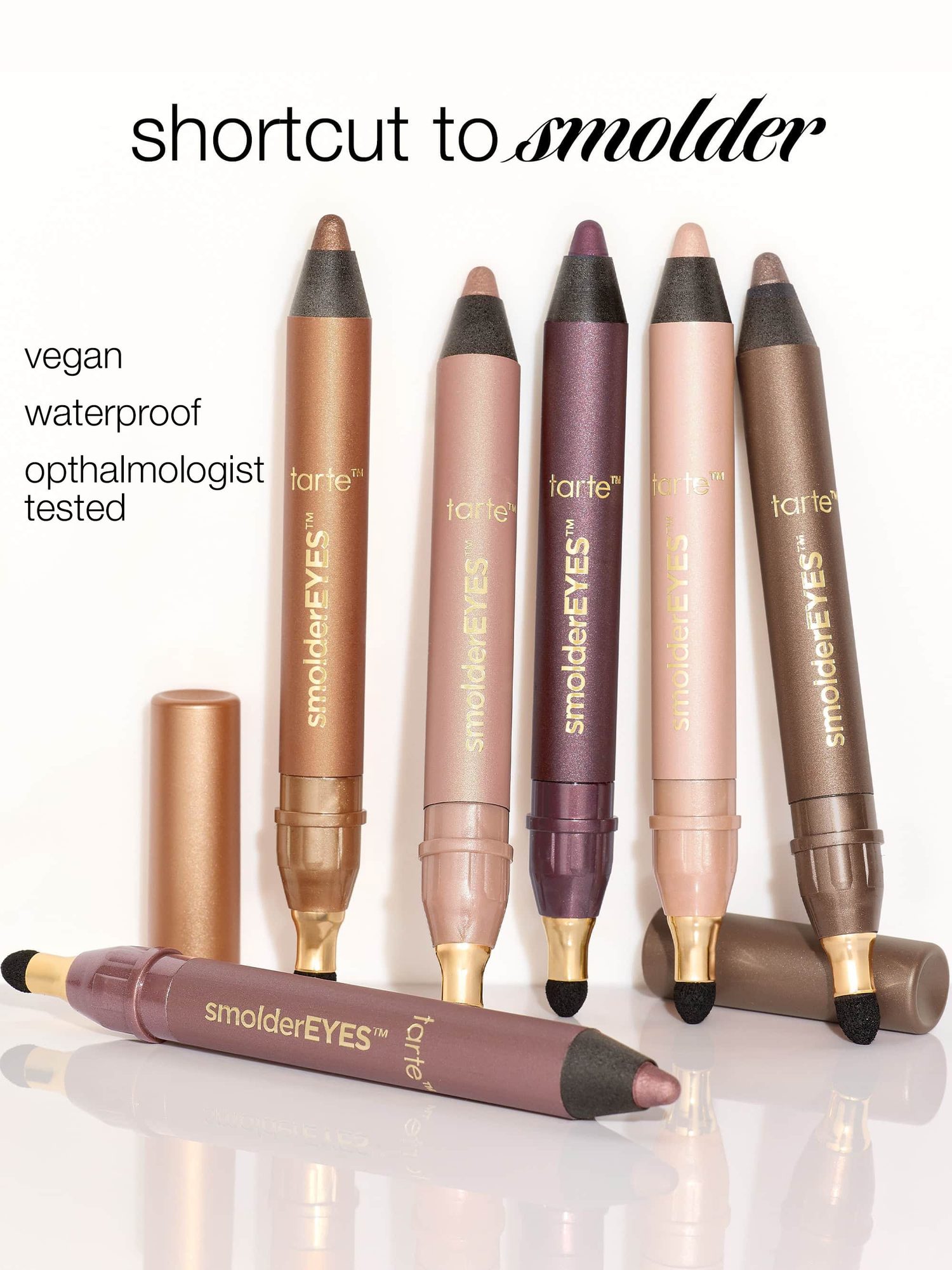Collection of shimmer eyeshadow pencils in various nude, bronze, and plum shades that are vegan and waterproof