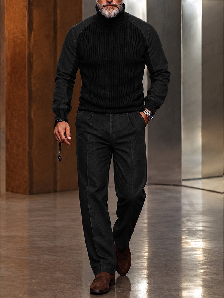 Man in black ribbed turtleneck, dark jeans, and brown suede shoes holding a cane
