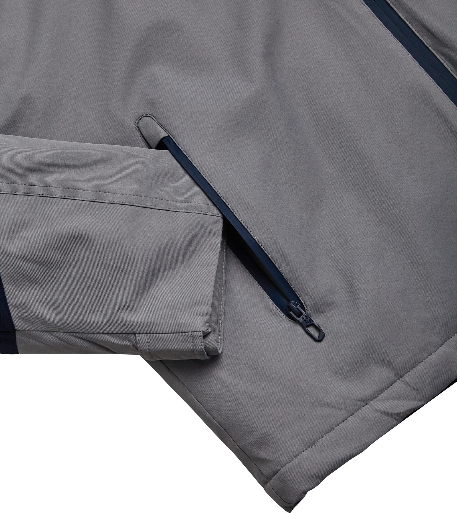 Gray sleeve with navy underarm panel and pit zipper detail on ski jacket
