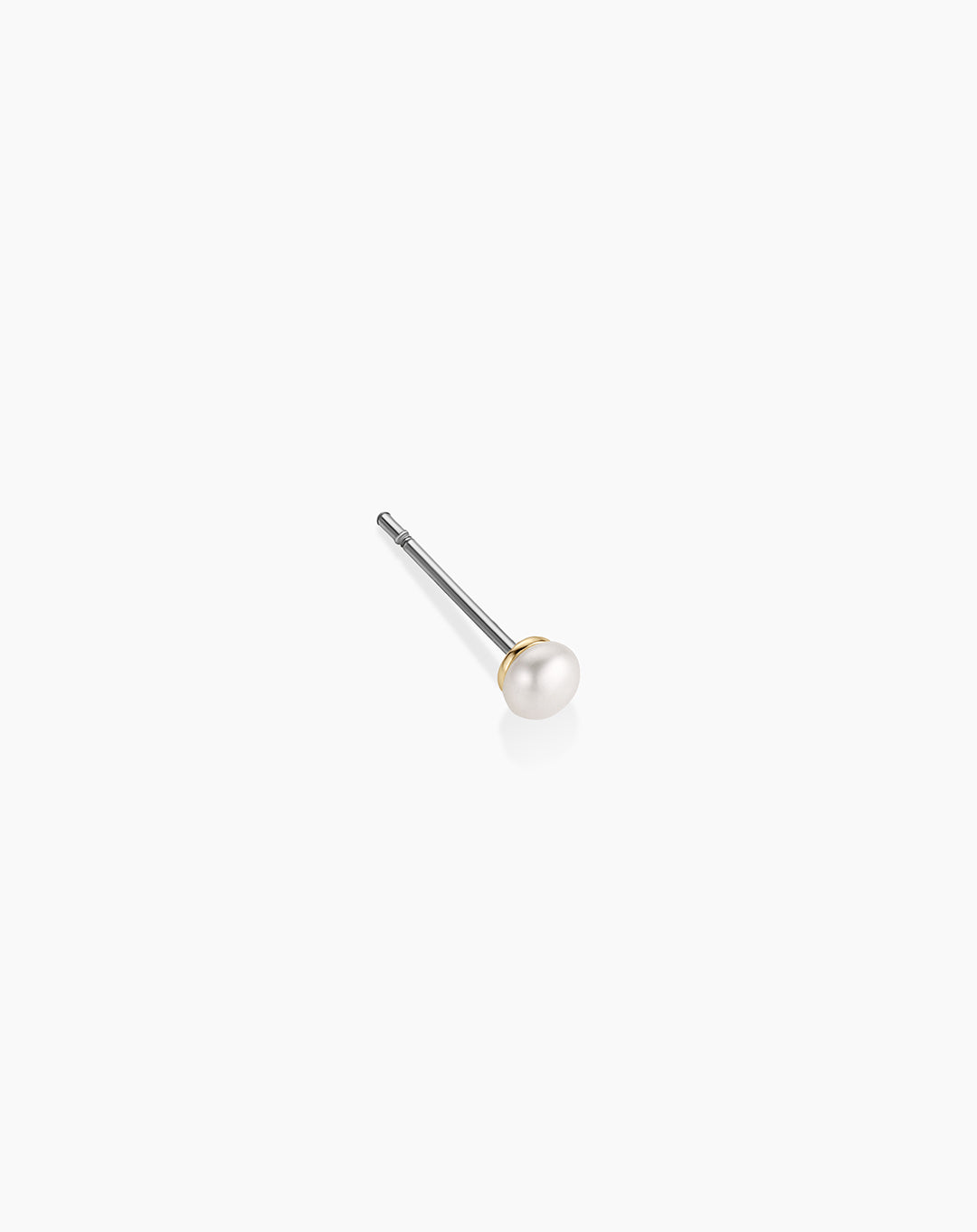 Pearl stud earring with gold accent and surgical steel post on white background