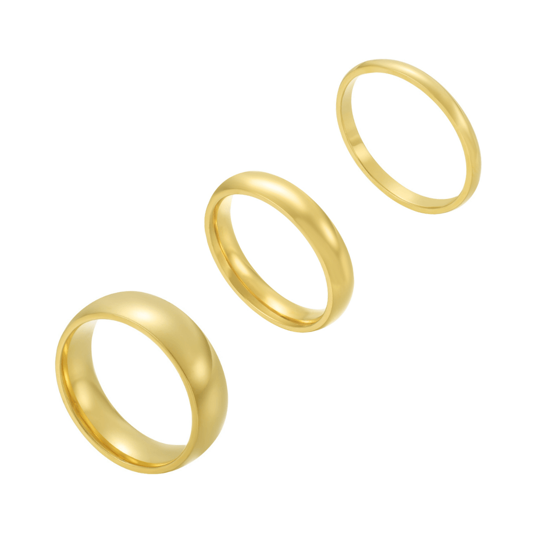 Three polished gold band rings displayed on white background