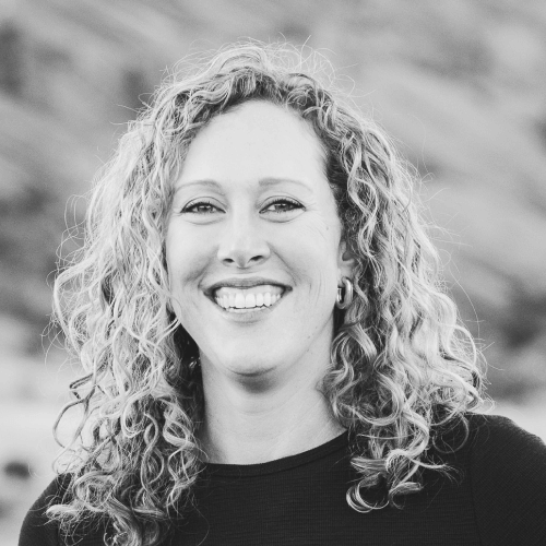 Black and white portrait of a smiling woman with curly hair