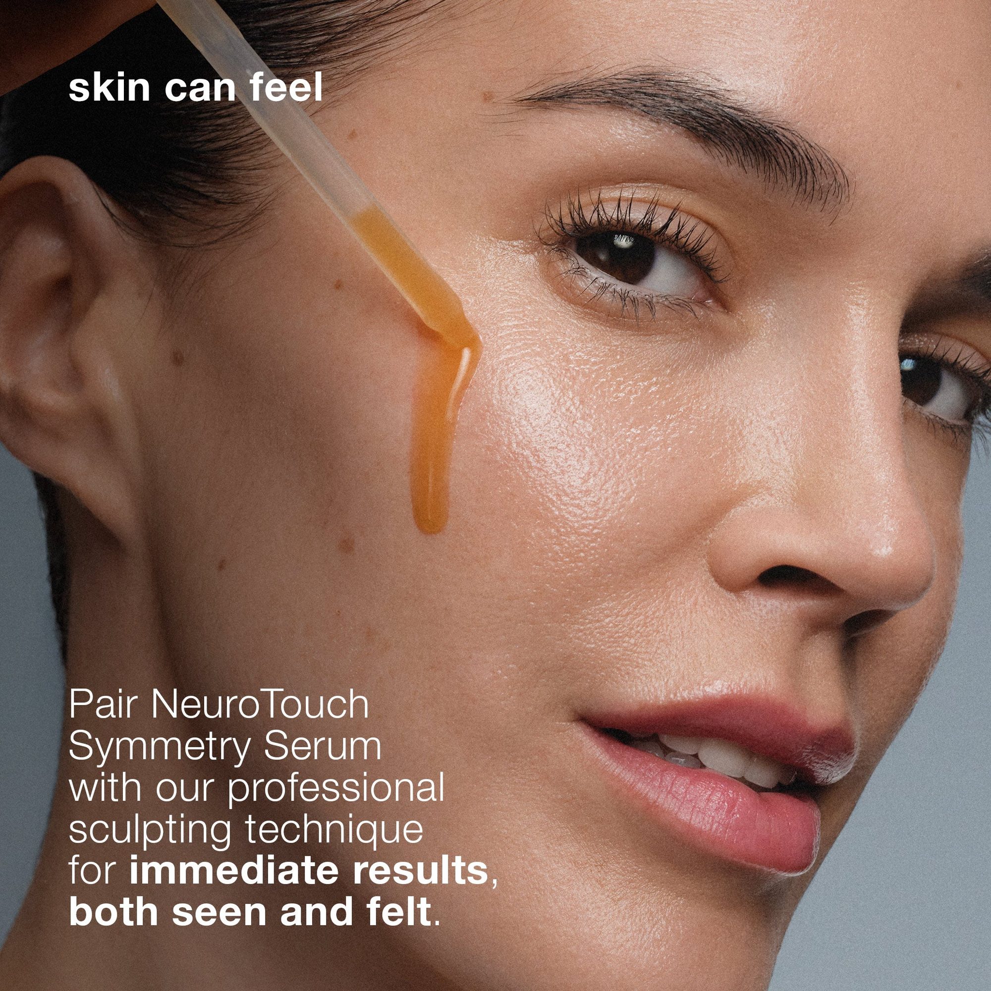 Woman's face in profile with golden serum dripping down cheek, demonstrating product application