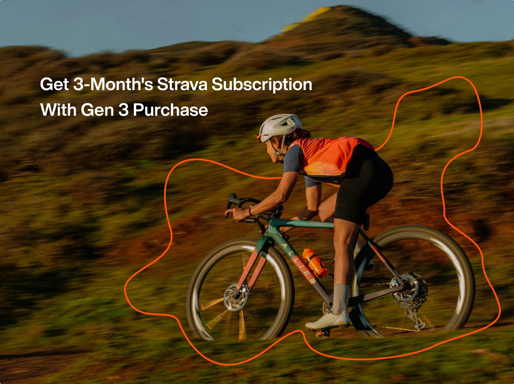 Cyclist riding downhill on grassy terrain wearing orange vest and white helmet