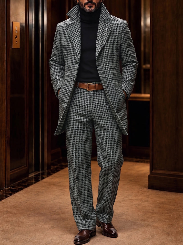 Man in houndstooth pattern suit jacket and pants with black turtleneck and brown leather shoes