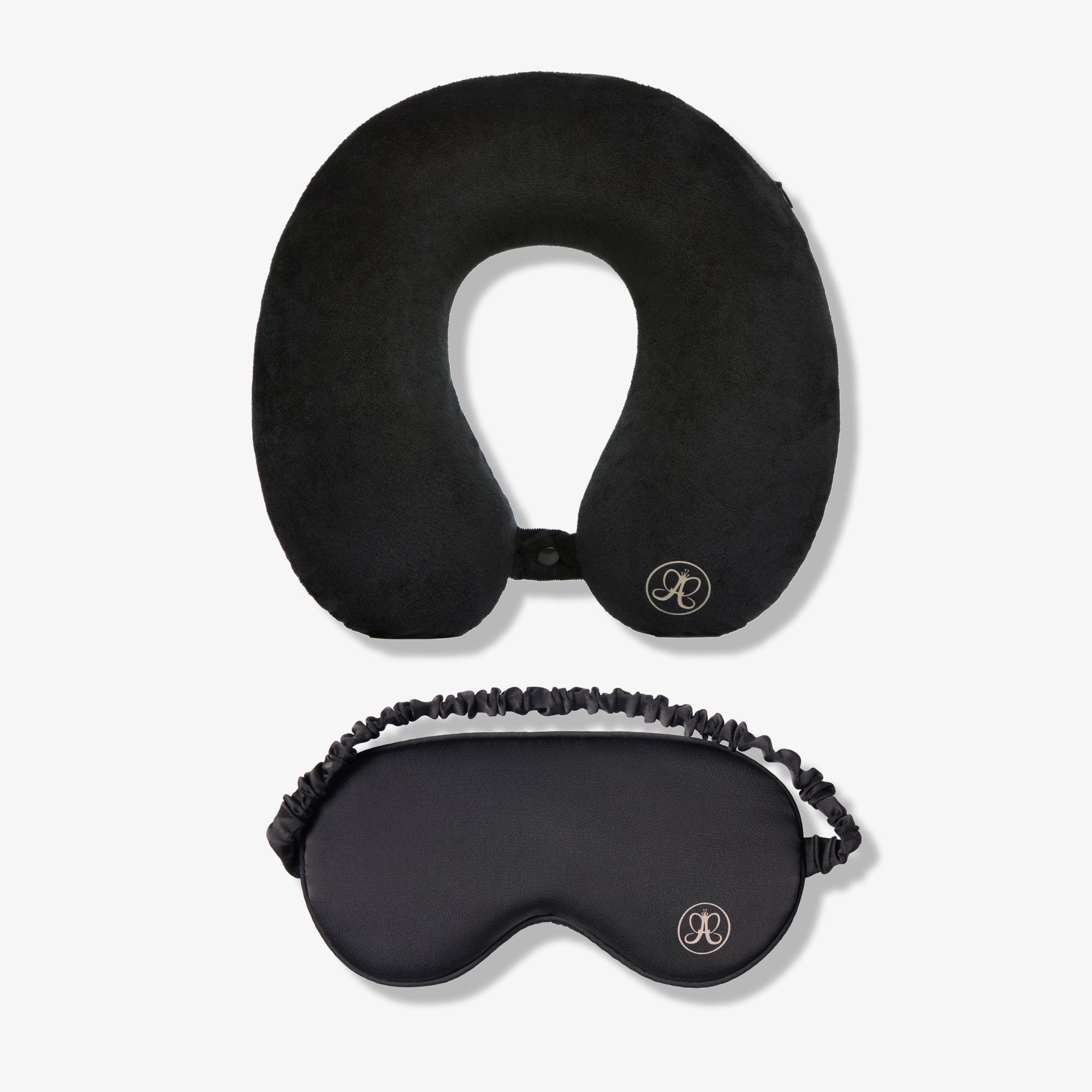 Black u-shaped neck pillow and contoured sleep mask set with branded logo