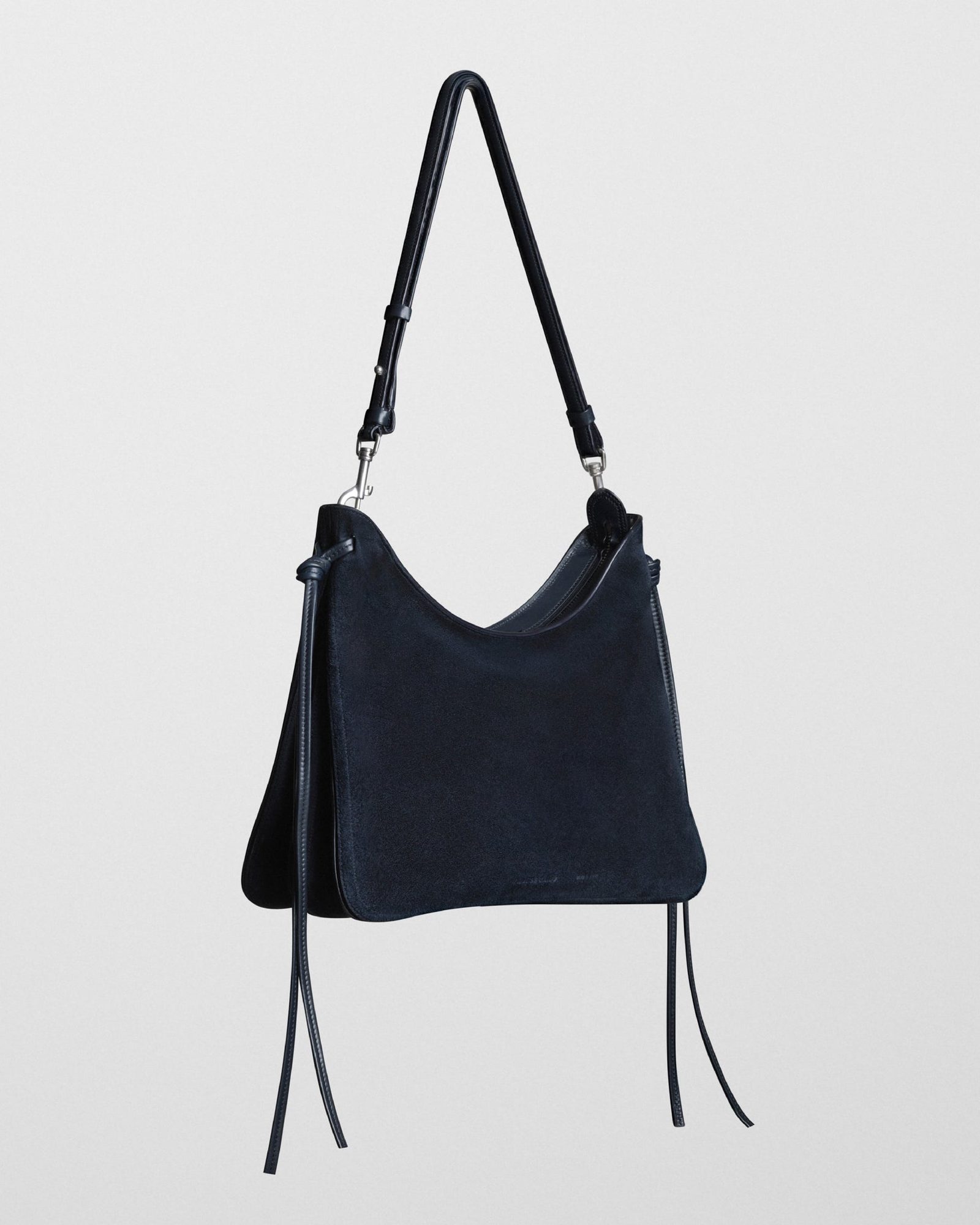 Navy suede hobo bag shown from front with long shoulder straps and leather trim