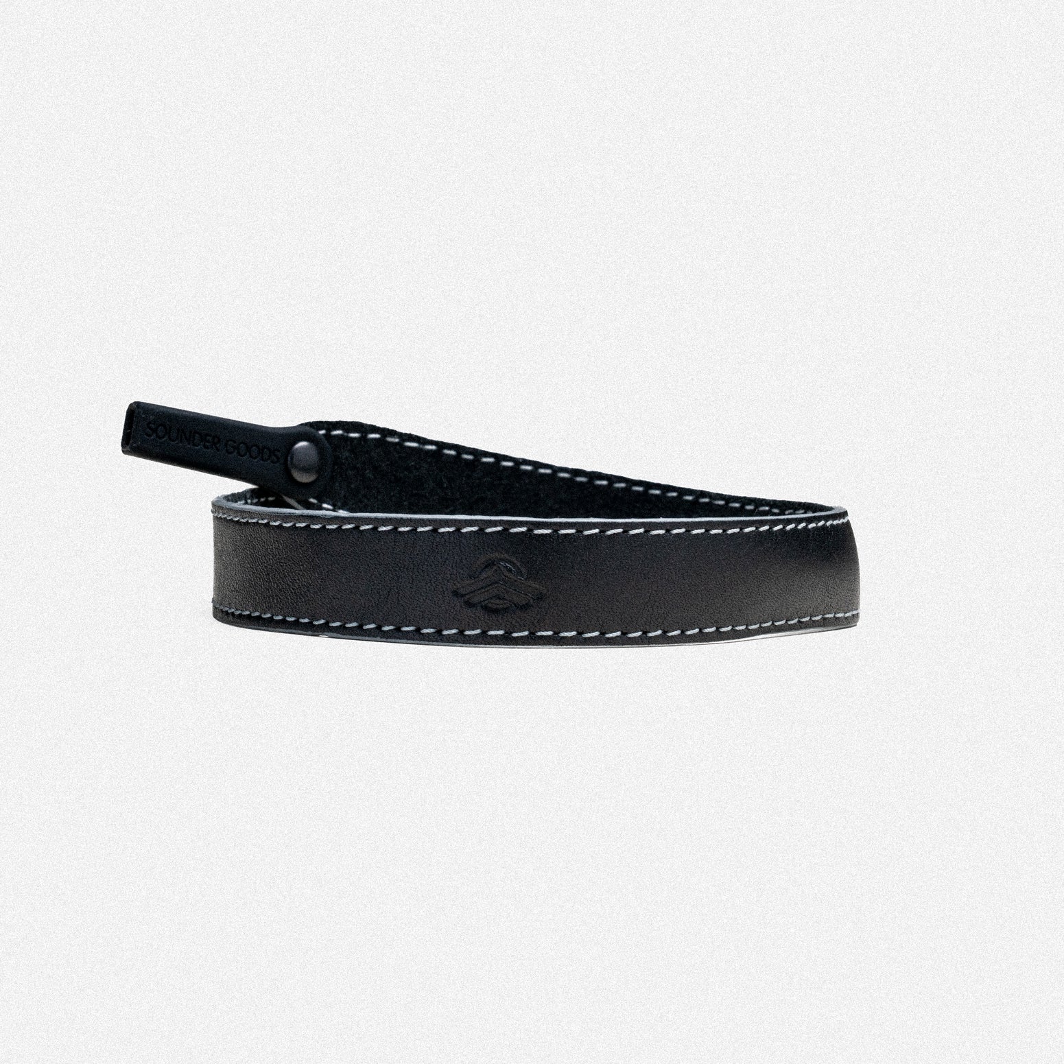 Black leather camera strap with white stitching and metal attachment