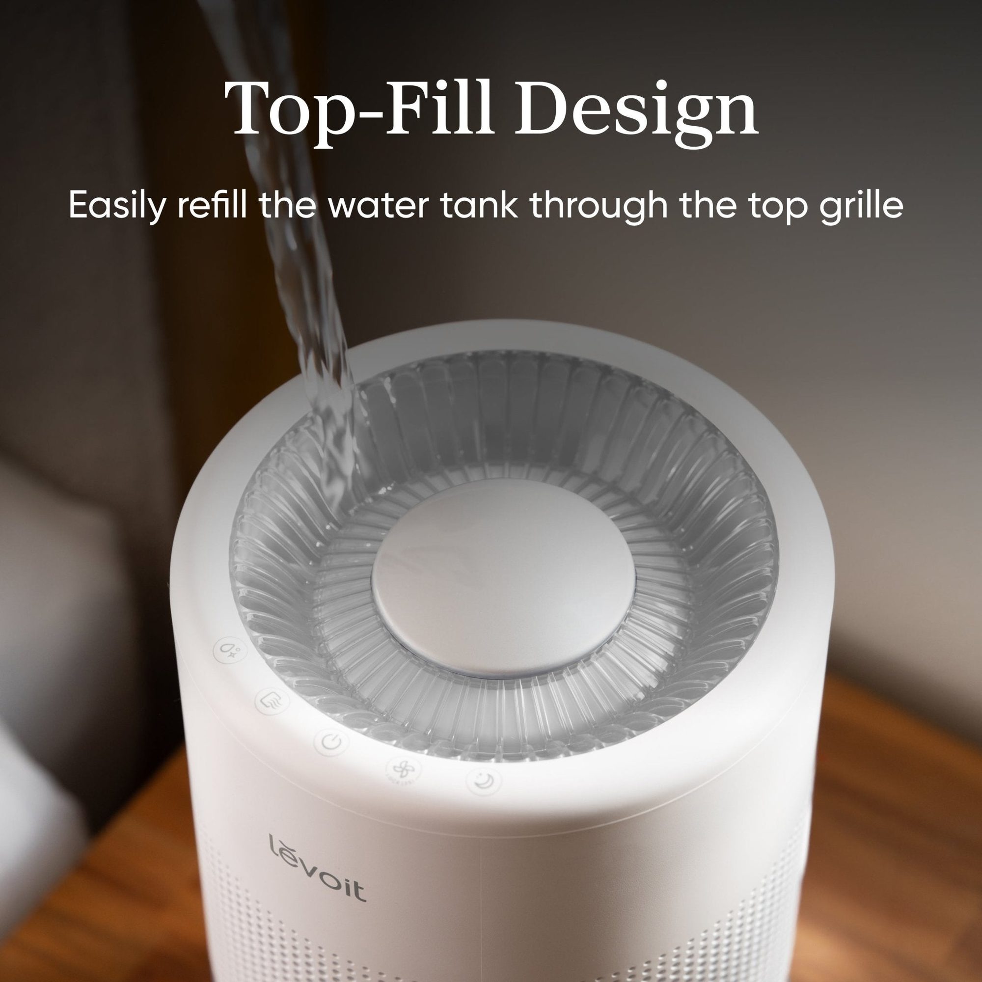Top view of white humidifier being filled with water through top grille opening