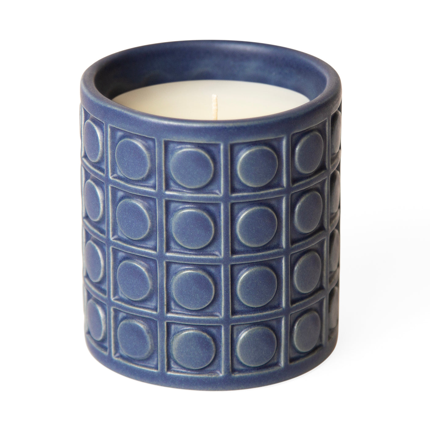 Blue ceramic candle with geometric circle and square pattern, unlit with white wax inside