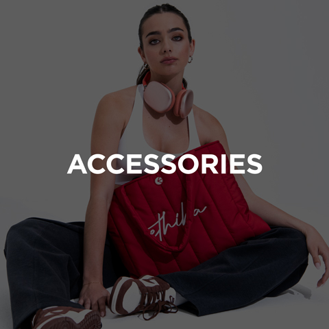 Woman sitting with red headphones around neck wearing red tank top