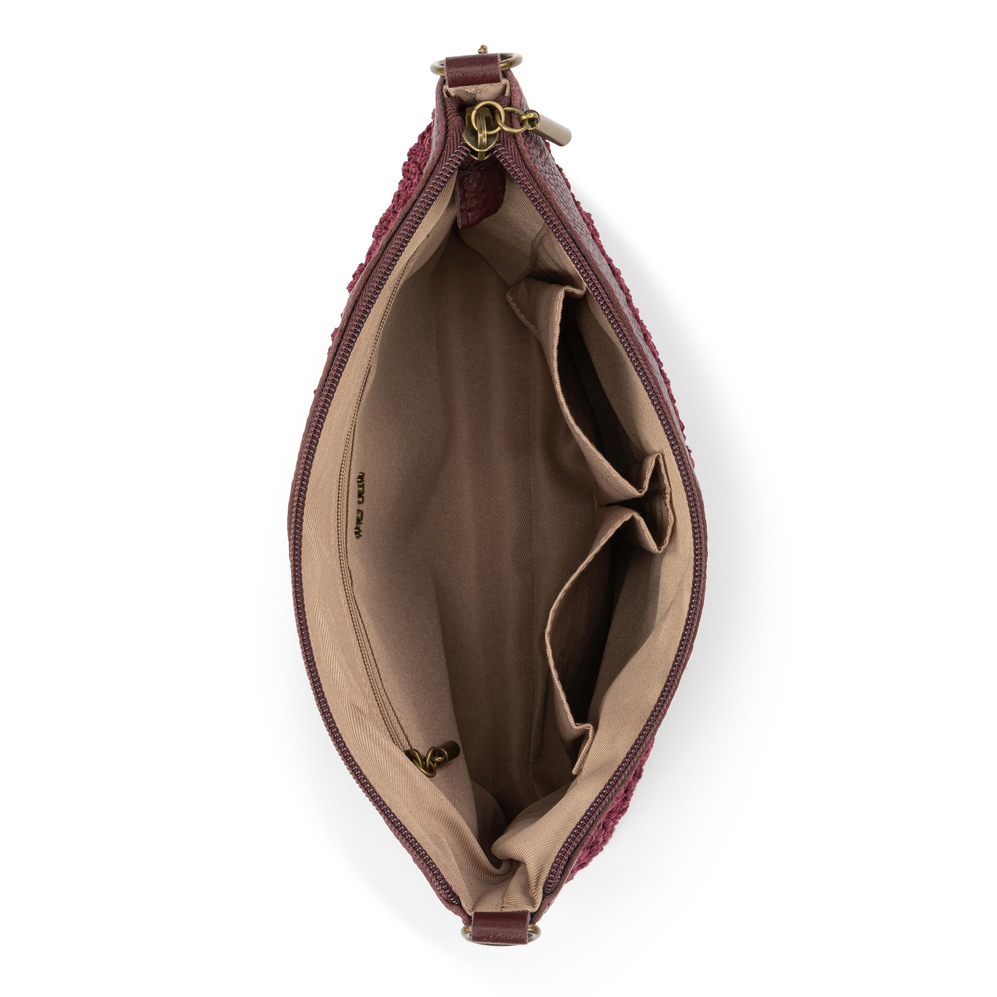Interior view of burgundy quilted bag showing beige lining and compartments