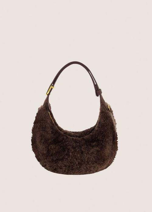 Dark brown chunky knit hobo shoulder bag with gold hardware on cream background