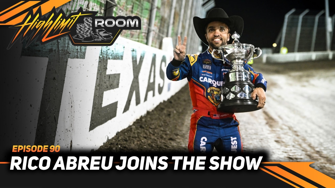 NAPA-sponsored drag racing driver in cowboy hat holding trophy at racing event
